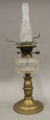 A Victorian brass and cut glass oil lamp with green glass shade