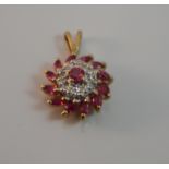 A 9 ct gold diamond and ruby pendant