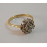An 18 ct gold diamond cluster ring (3.