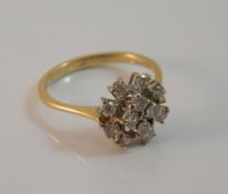 An 18 ct gold diamond cluster ring (3.