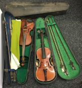 Two vintage cased violins and a vacant case