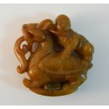A Chinese carved agate roundel