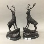 A pair of bronze model stags