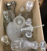 A quantity of cut glass decanters, etc.