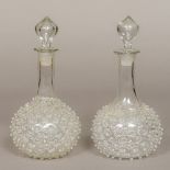 A pair of unusual 19th century blown glass decanters and stoppers, both with 'studded' decoration.