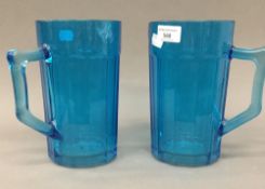 A pair of blue glass jugs