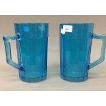 A pair of blue glass jugs