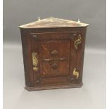 A 19th century brass mounted oak corner cupboard