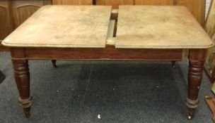 A Victorian mahogany extending dining table with two original leaves (with two further associated