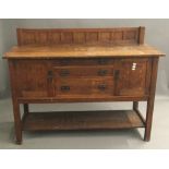 An Arts and Crafts oak sideboard by L & J G Stickley. 116 cm high, 56 cm deep, 153 cm wide.