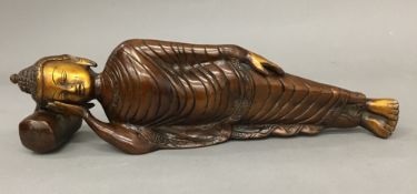 A bronze figure of Buddha modelled reclining