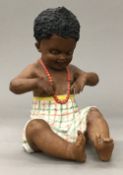 A Victorian porcelain piano baby. 18 cm high (seated).