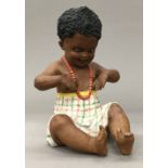 A Victorian porcelain piano baby. 18 cm high (seated).