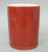 A Chinese sang de boeuf red porcelain brush pot