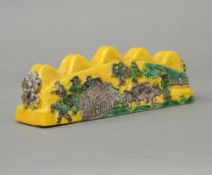 A Chinese yellow porcelain brush rest