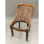 An early 19th century mahogany framed bergere chair