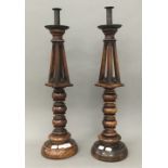A pair of 19th century turned fruitwood candlesticks. 64 cm high.