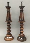 A pair of 19th century turned fruitwood candlesticks. 64 cm high.