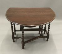 An oak barley twist drop leaf table