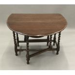 An oak barley twist drop leaf table