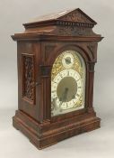 A Victorian walnut mantle clock