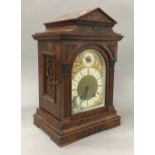 A Victorian walnut mantle clock