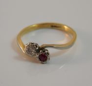 A 1940s 18 ct gold diamond and ruby crossover ring (2.