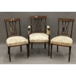 An Edwardian inlaid mahogany open armchair and a pair of matching single chairs