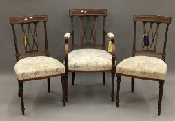 An Edwardian inlaid mahogany open armchair and a pair of matching single chairs