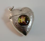 A silver vesta shaped as a heart