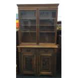 A Victorian glazed bookcase cabinet. 220 cm high, 49 cm deep, 123 cm wide.