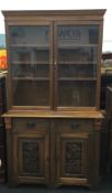 A Victorian glazed bookcase cabinet. 220 cm high, 49 cm deep, 123 cm wide.