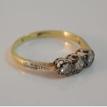 An 18 ct gold diamond three stone ring (2.
