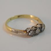 An 18 ct gold diamond three stone ring (2.