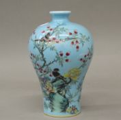 A Chinese blue porcelain vase decorated with birds amongst foliage