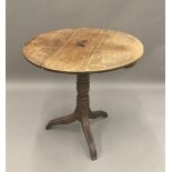 A George III oak tilt top tripod table