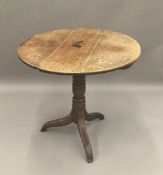 A George III oak tilt top tripod table