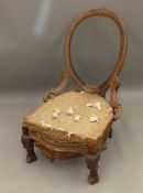 A Victorian walnut framed balloon back easy chair (for re-upholstery)