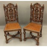 A pair of Victorian Edwards & Roberts carved oak hall chairs