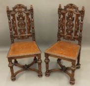 A pair of Victorian Edwards & Roberts carved oak hall chairs