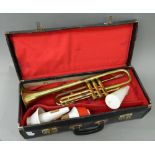 A cased brass trumpet