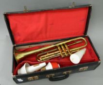 A cased brass trumpet