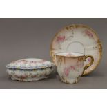 A decorative Limoges ceramic cup and saucer,