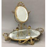 A Victorian brass and mirrored stand with twin candle sconces