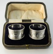 A cased pair of silver napkin rings