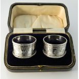 A cased pair of silver napkin rings