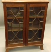 A Victorian mahogany glazed bookcase. 127 cm high; 30 cm deep, 97 cm wide.