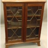 A Victorian mahogany glazed bookcase. 127 cm high; 30 cm deep, 97 cm wide.