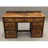 An early 20th century carved oak dressing table