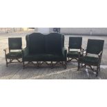 An early 20th century camel back settee and three matching armchairs